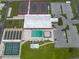 Aerial view of community pool, tennis courts, and clubhouse at 4590 Oakley Rd, North Port, FL 34288