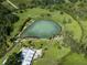 Aerial view of spring-fed pool surrounded by lush greenery at 4590 Oakley Rd, North Port, FL 34288