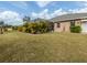 Landscaped backyard with lush greenery and screened pool at 4590 Oakley Rd, North Port, FL 34288