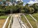 Aluminum ramp provides access to a waterway from the grassy bank at 4590 Oakley Rd, North Port, FL 34288