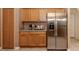 Modern kitchen with stainless steel appliances and wood cabinets at 4590 Oakley Rd, North Port, FL 34288