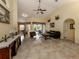 Living room with dark leather couch and view to dining area at 4590 Oakley Rd, North Port, FL 34288