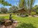 Bronze statue of a boy reading sits on a rock in a park near a shaded bench at 4590 Oakley Rd, North Port, FL 34288