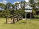 Wooden walkway leads to a small dock over calm water with lush vegetation at 4590 Oakley Rd, North Port, FL 34288