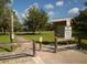 Brick pathway entrance to a park with wooden posts and signage at 4590 Oakley Rd, North Port, FL 34288