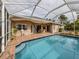 Large screened pool and patio area with seating at 4590 Oakley Rd, North Port, FL 34288