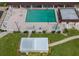 Community pool with surrounding lounge chairs and hot tub at 4590 Oakley Rd, North Port, FL 34288