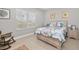 Bright bedroom with a comfortable bed and a rocking chair at 4649 Willow Bend Ave, Parrish, FL 34219