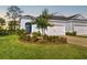 Two-story house with gray siding, two-car garage, and well-manicured landscaping at 4649 Willow Bend Ave, Parrish, FL 34219