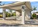 Outdoor kitchen and dining area with grills and tables at 4649 Willow Bend Ave, Parrish, FL 34219