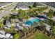 Aerial view of community pool with patio furniture and cabana at 4649 Willow Bend Ave, Parrish, FL 34219