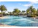 Large community pool with palm trees and lounge chairs at 4649 Willow Bend Ave, Parrish, FL 34219