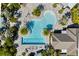 Aerial view of resort-style pool with surrounding lounge chairs and landscaping at 4649 Willow Bend Ave, Parrish, FL 34219