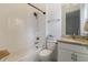 Simple bathroom with tub shower combo, granite countertop, and white cabinets at 4839 Pastel Ct, Sarasota, FL 34240