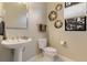 Powder room with pedestal sink and decorative wall art at 4839 Pastel Ct, Sarasota, FL 34240