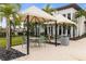 Poolside cabanas with seating for relaxing by the pool at 4839 Pastel Ct, Sarasota, FL 34240