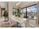 Bright dining room with white table and chairs, overlooking pool and golf course at 4839 Pastel Ct, Sarasota, FL 34240