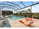 Inviting pool area with expansive lanai and relaxing lounge chairs at 4839 Pastel Ct, Sarasota, FL 34240