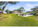 Landscaped backyard with pool, patio, and waterfront access at 504 68Th Avenue W Dr, Bradenton, FL 34207