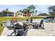 Relaxing backyard patio with fire pit and seating area, overlooking a beautiful pool and the canal at 504 68Th Avenue W Dr, Bradenton, FL 34207