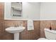 Small bathroom with pedestal sink and tile floor at 504 68Th Avenue W Dr, Bradenton, FL 34207