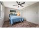 Bright bedroom with blue bedding and ceiling fan at 504 68Th Avenue W Dr, Bradenton, FL 34207