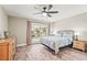 Main bedroom with water view and ceiling fan at 504 68Th Avenue W Dr, Bradenton, FL 34207