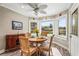 Charming dining area featuring a wooden table, four chairs, and water views at 504 68Th Avenue W Dr, Bradenton, FL 34207