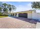 Brick driveway leads to a home with a dark brown garage door at 504 68Th Avenue W Dr, Bradenton, FL 34207