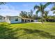 Single-story home with a large front yard and palm trees at 504 68Th Avenue W Dr, Bradenton, FL 34207