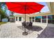 Relaxing patio with seating area and red umbrella at 504 68Th Avenue W Dr, Bradenton, FL 34207