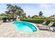 Kidney-shaped pool with ample patio space for sunbathing and relaxation at 504 68Th Avenue W Dr, Bradenton, FL 34207