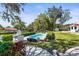 Private kidney shaped pool with patio and lush landscaping at 504 68Th Avenue W Dr, Bradenton, FL 34207