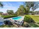 Inviting kidney-shaped pool with patio and lush landscaping at 504 68Th Avenue W Dr, Bradenton, FL 34207