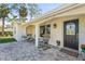 Front porch with rocking chairs and welcoming door at 504 68Th Avenue W Dr, Bradenton, FL 34207