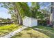 White storage shed with paved pathway at 504 68Th Avenue W Dr, Bradenton, FL 34207