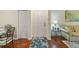 Bright condo entryway with hardwood floors and coat closet at 5180 Northridge Rd # 211, Sarasota, FL 34238