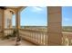 Spacious balcony with tranquil water views and potted plants at 5531 Cannes Cir # 802, Sarasota, FL 34231