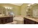 Elegant bathroom with double sinks, granite counters, and a large soaking tub at 5531 Cannes Cir # 802, Sarasota, FL 34231