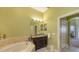 Bathroom with a single vanity, tub shower combo, and updated fixtures at 5531 Cannes Cir # 802, Sarasota, FL 34231