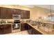 Modern kitchen featuring stainless steel appliances and granite countertops at 5531 Cannes Cir # 802, Sarasota, FL 34231