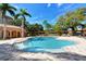 Inviting resort-style pool with surrounding patio and lush landscaping at 5531 Cannes Cir # 802, Sarasota, FL 34231