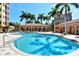 Inviting resort-style pool with lounge chairs at 5531 Cannes Cir # 802, Sarasota, FL 34231