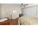 Spacious bedroom with wood floors, ceiling fan, and large closet at 5539 Holiday Park Blvd, North Port, FL 34287