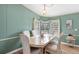 Bright dining room with bay window and seating for four at 5539 Holiday Park Blvd, North Port, FL 34287