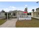 Front view of a manufactured home with a carport at 5539 Holiday Park Blvd, North Port, FL 34287