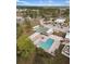 L-shaped pool with surrounding lounge chairs at 5539 Holiday Park Blvd, North Port, FL 34287