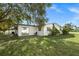 House's side yard with patio, grass and landscaping at 5823 26Th W St, Bradenton, FL 34207