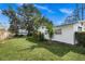 Spacious grassy backyard with mature trees and shrubs at 5823 26Th W St, Bradenton, FL 34207