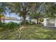 Large backyard with mature trees and a partially fenced area at 5823 26Th W St, Bradenton, FL 34207